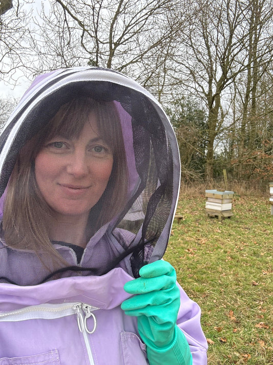 Female Beekeeper getting ready to do winter checks on hives